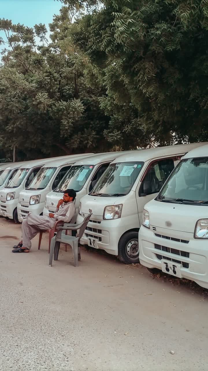 A fleet of white vans parked in a row